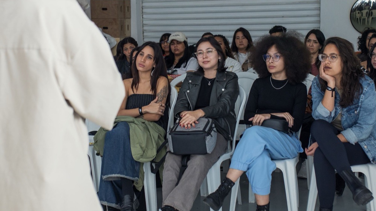 An audience listening attentively to a speaker at an indoor talk