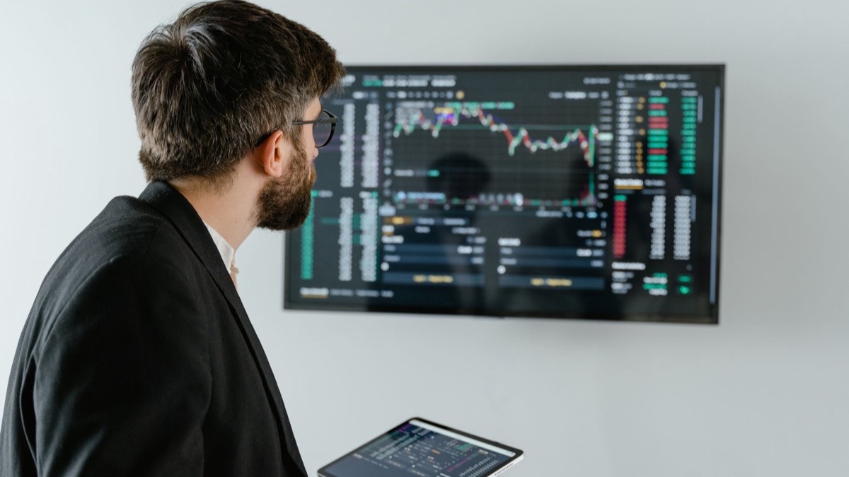 An analyst reviewing data on a screen at a desk