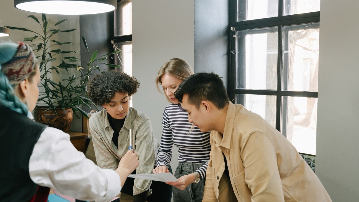 Young professionals brainstorming together around a table in a modern workspace