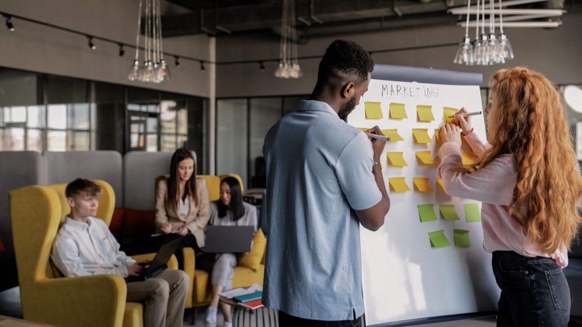 A team planning strategy on a whiteboard in a bright office