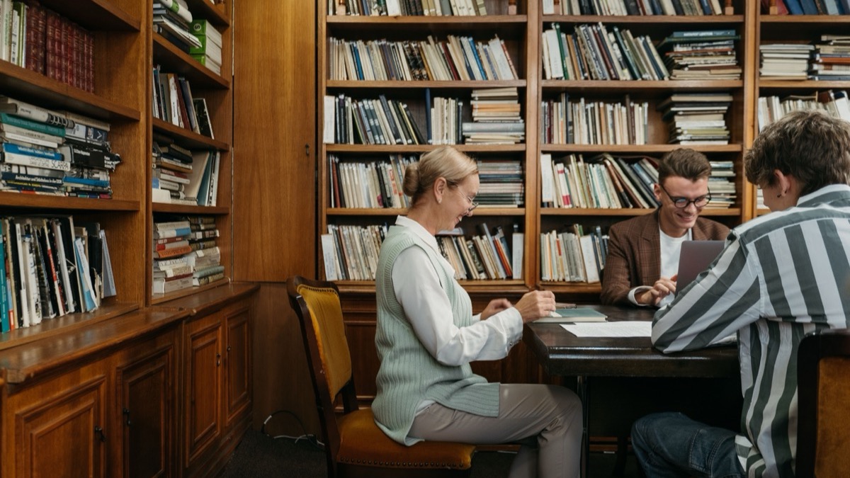 Researchers working in a university library reading room